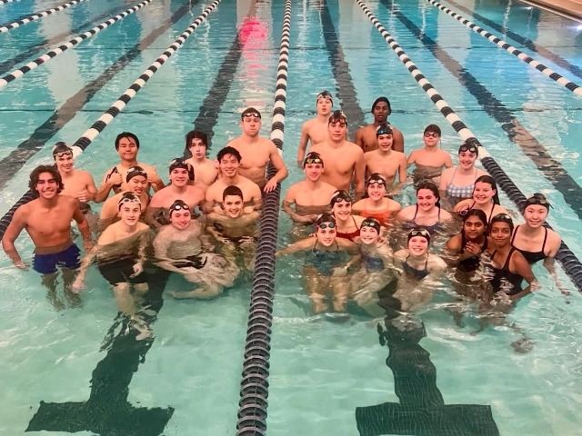 The boys and girls swim team poses for team picture.