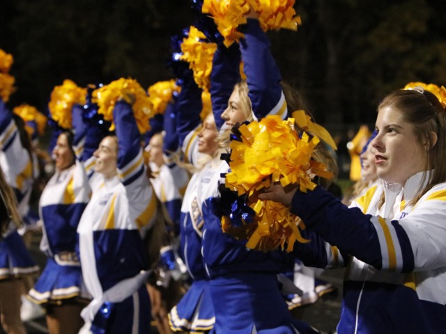 The cheer team pumps up the student section. The team dose cants and stunts to keep the energy up between plays.
