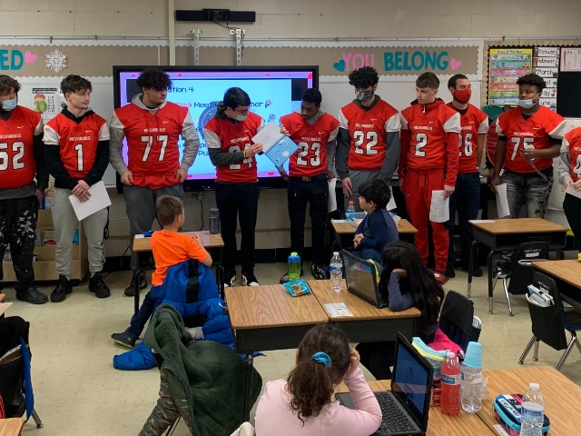 MHS Football Players Read to Rogers Students.