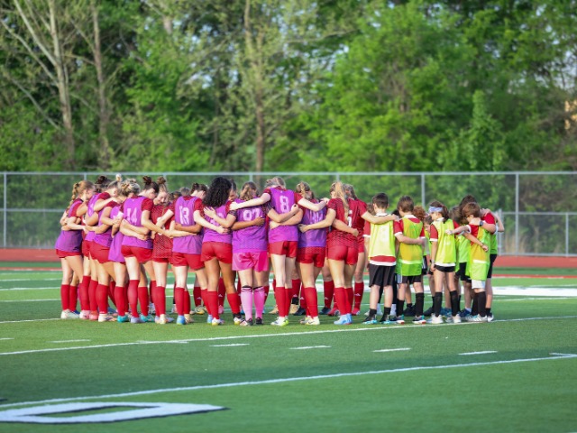 2026 girls soccer team in a huddle 