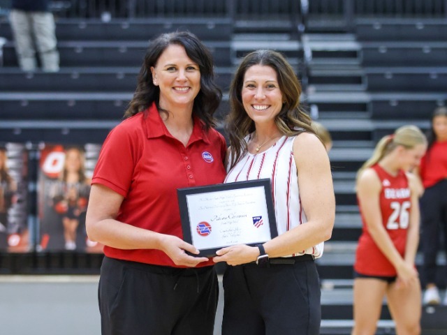 Adeana Chrestman holding plaque being honored as NFHS MSHSAA Girls Volleyball Coach of the Year