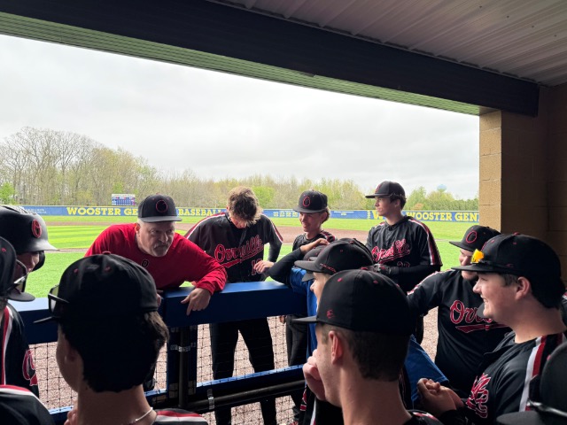Coach Jimmy gives the team a pep talk before the game