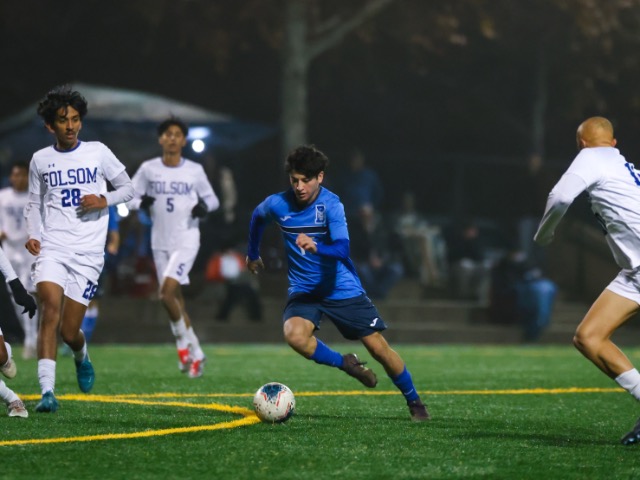 Davis High junior midfielder Noah Arnold charges past Folsom defenders on the halfway line on Dec. 13.