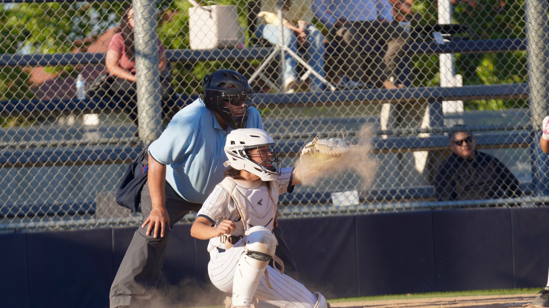 Slide 1 - Aubrie Jenkins #9  the catcher for the team receiving a ball with dust kicking up.