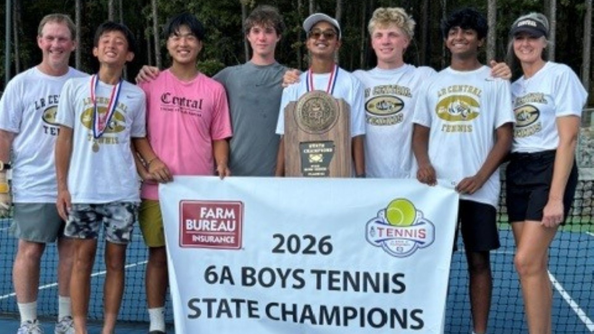 Female coach and male coach along with boys tennis team of Central High Boys Tennis team holding the 2026 6A Boys State Champion Banner and Trophy