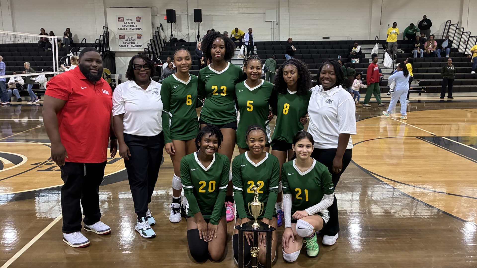 Forest Heights 8th graders along with coaches posing with the championship trophy.