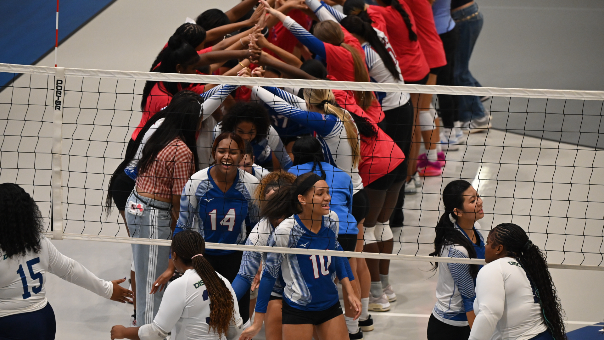 Slide 4 - JV Volleyball creates a tunnel for their Varsity Volleyball Team.
