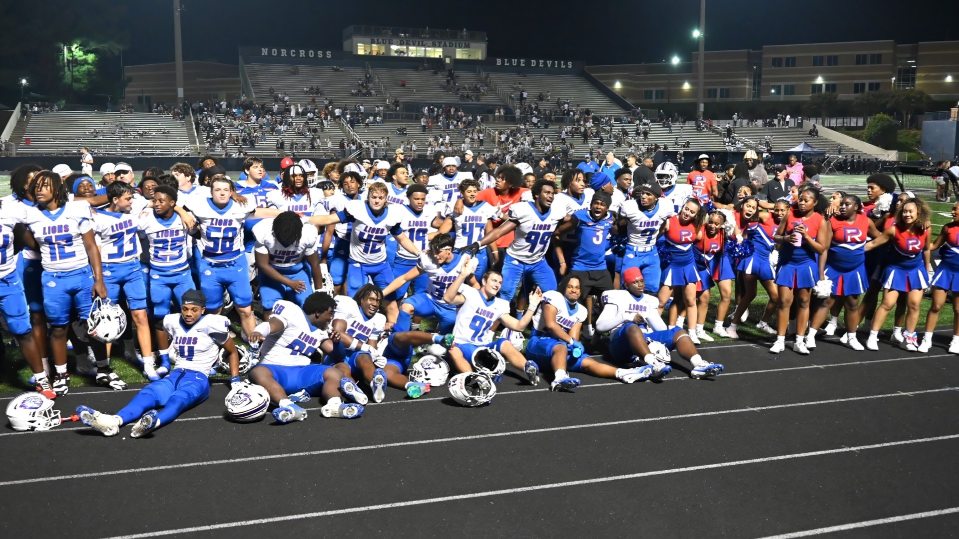 Slide 1 - Varsity Cheer & Football join together for the Alma Mater after their win against Norcross.