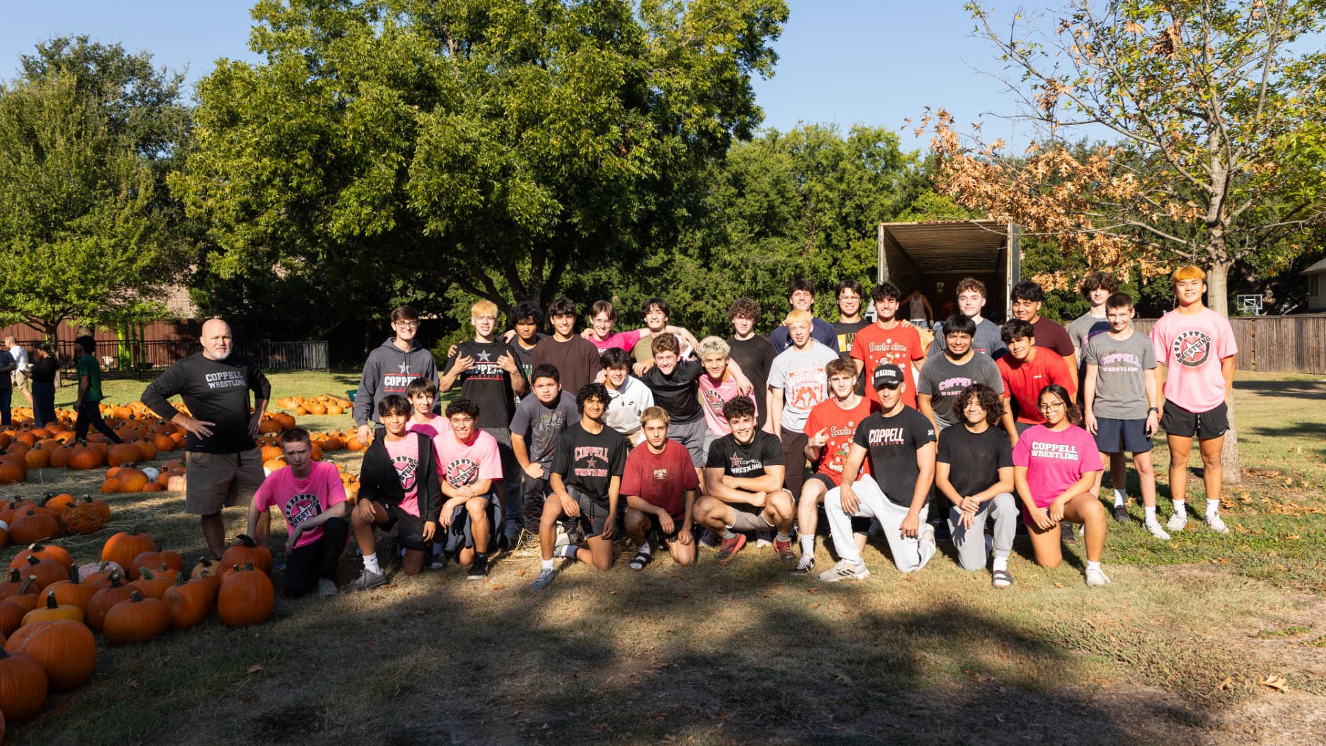 Slide 5 - Wrestling volunteers at the Pumpkin Patch