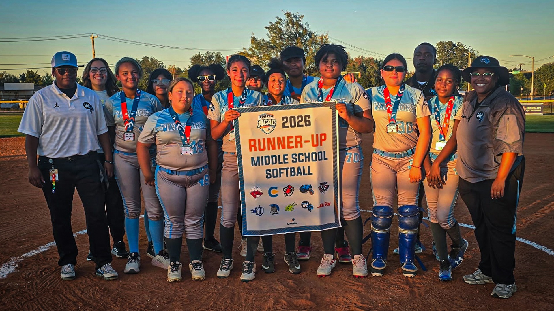 Slide 0 - Lady Warriors Receive 2026 ACAC Softball Runner-Up Banner