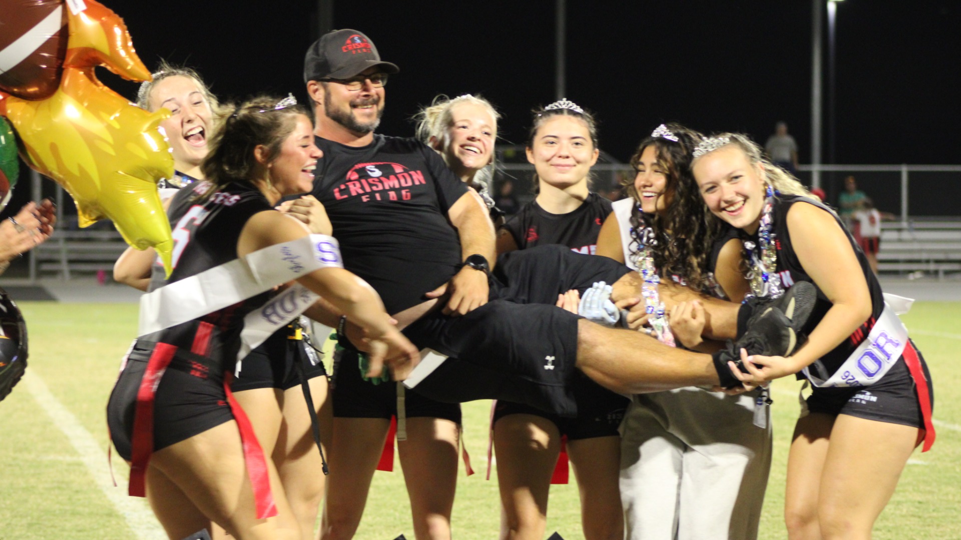 Slide 0 - Seniors holding Coach Mike-Senior Night