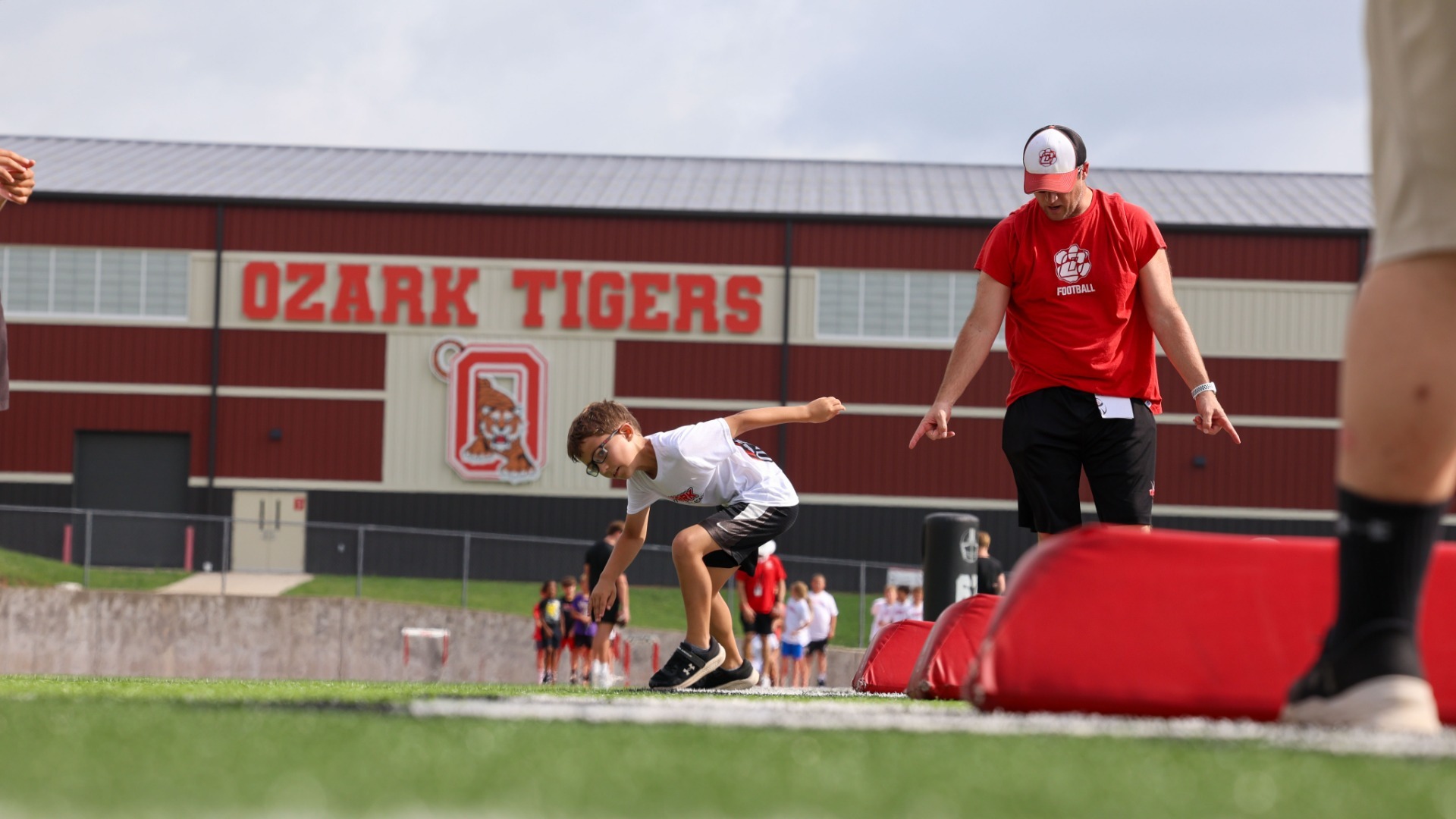 Slide 3 - Ozark Tigers Football host their annual summer youth camp