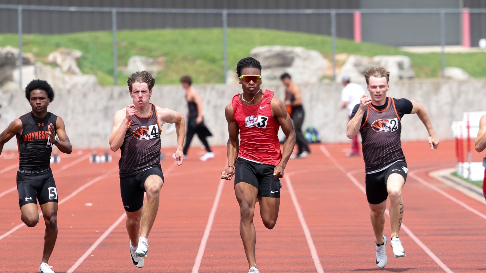 Slide 1 - Senior Kannon Williams sprints past the competition at the Christian County Relays