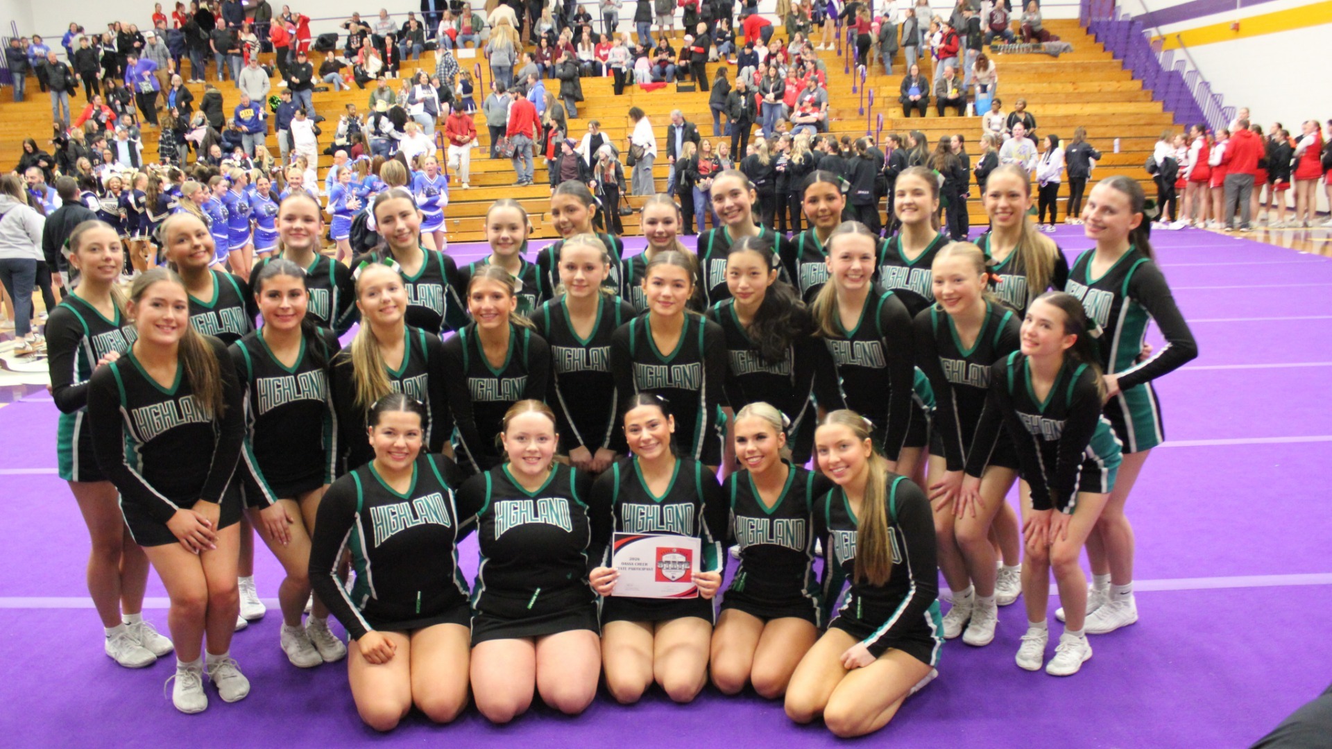 Cheer comp. team poses after their State tournament qualifying competition at Jackson High School