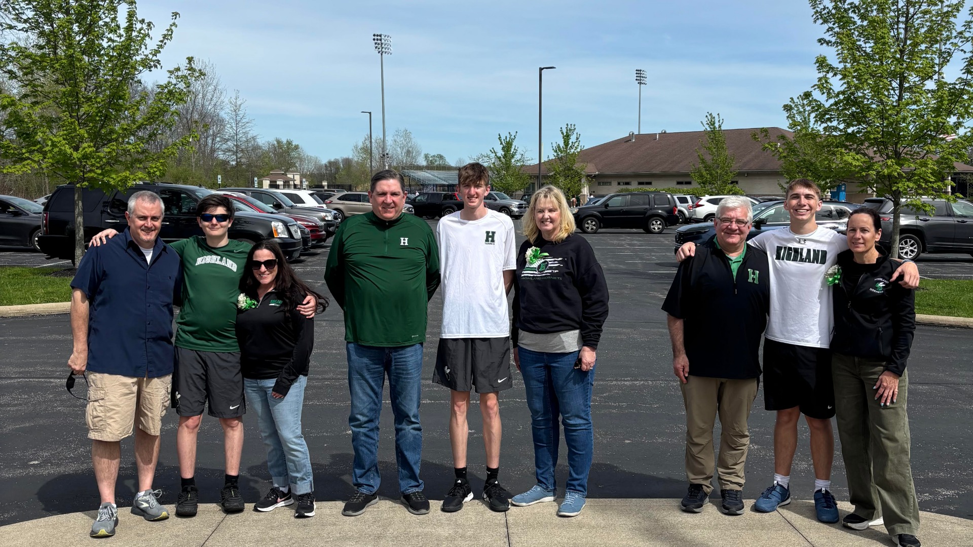 Team photo of boys and their parents on senior night