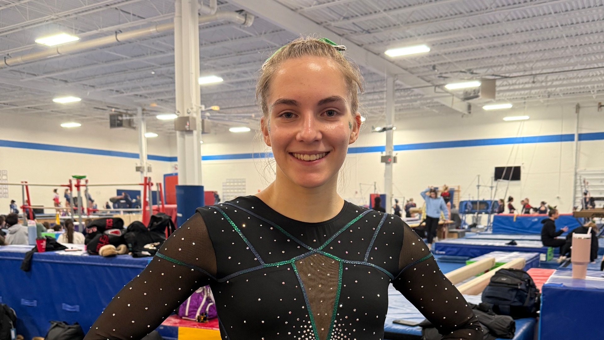 Ally standing in front of the balance beam.
