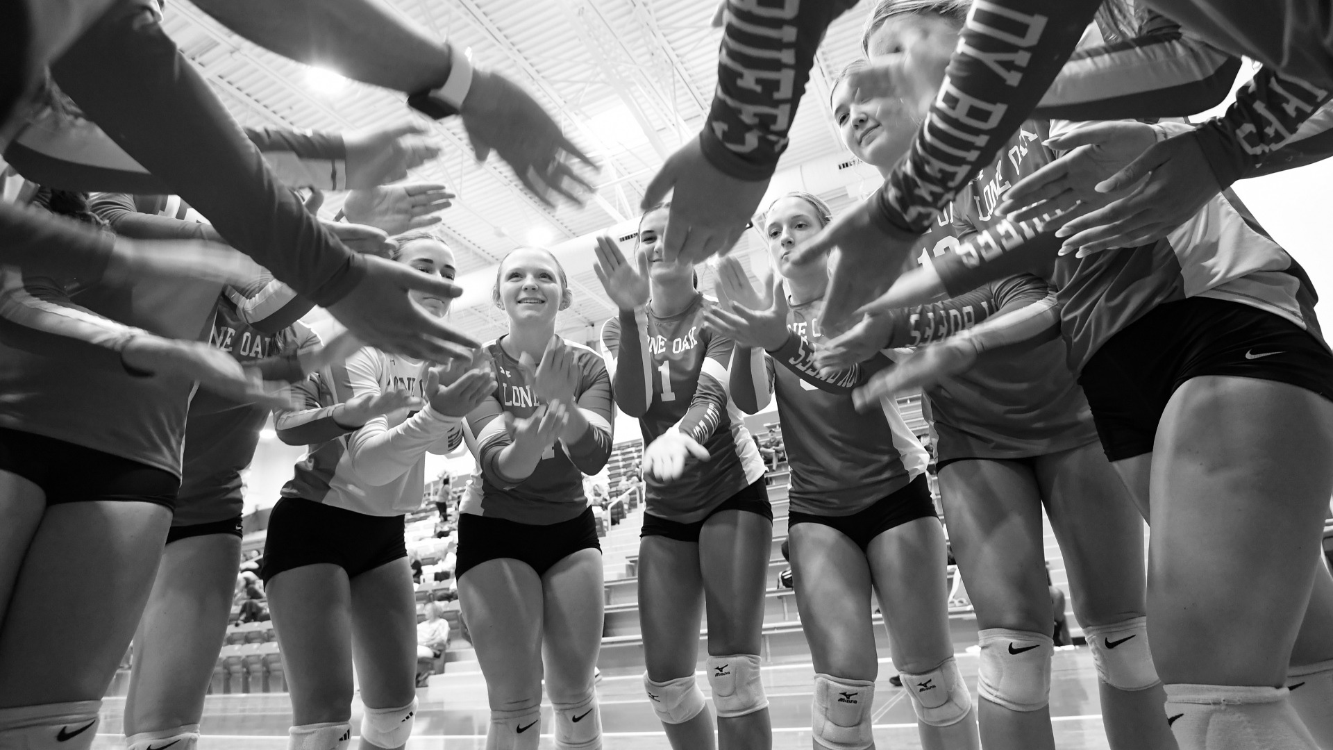 LOHS Varsity volleyball team huddle before play
