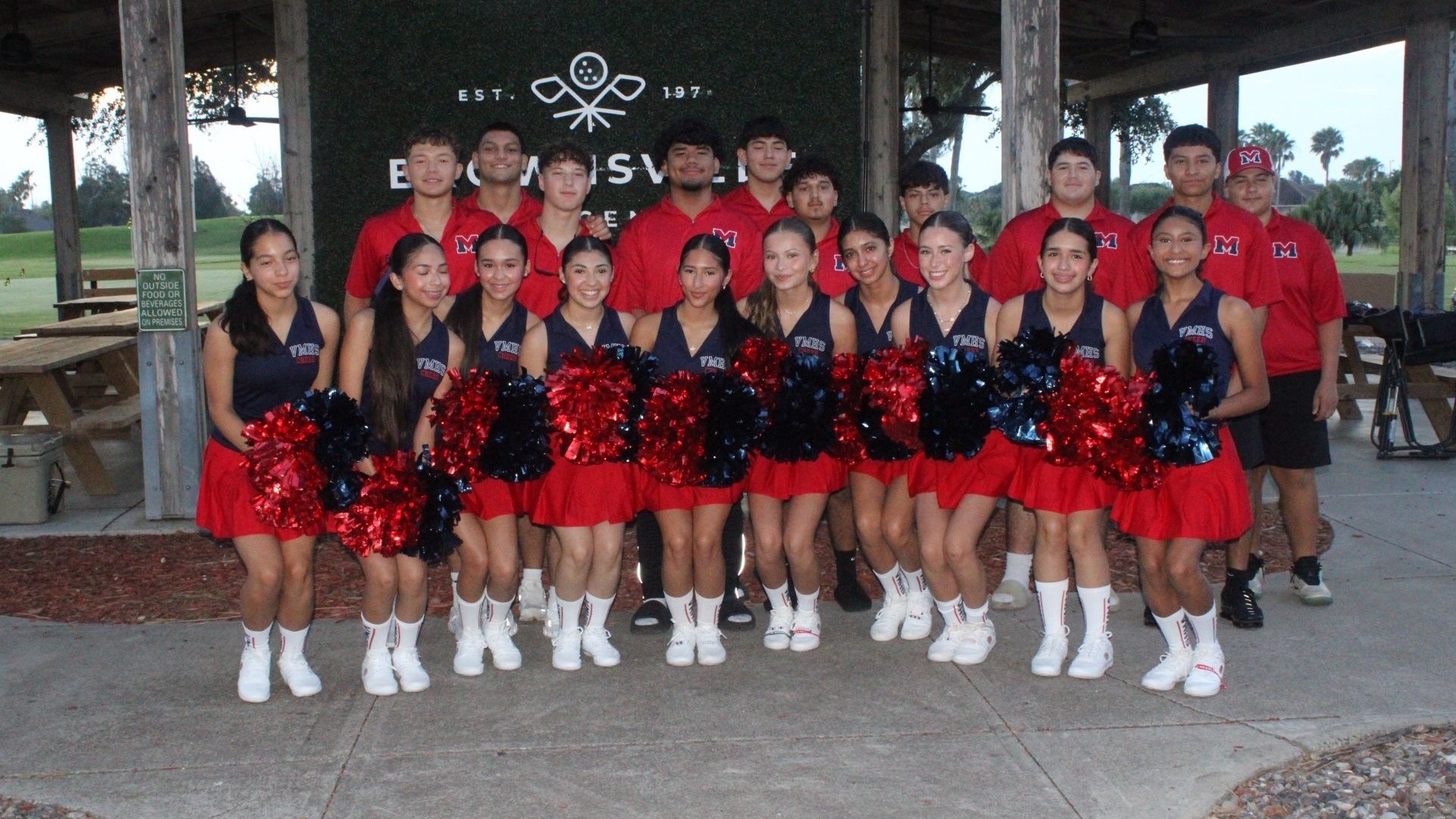 Slide 3 - Charger Football players and cheerleaders volunteer at the QB Club golf tournament. 