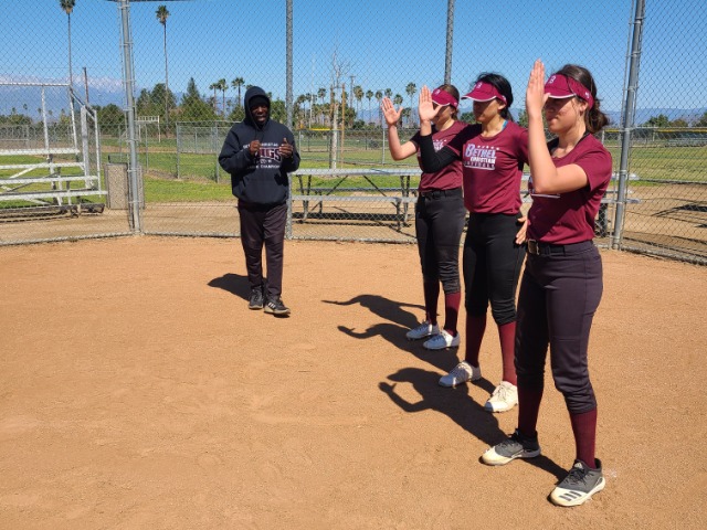 3.8.22 - The girls doing some training in how to run the bases quicker by Coach Earl, Head Coach of Track & Field.