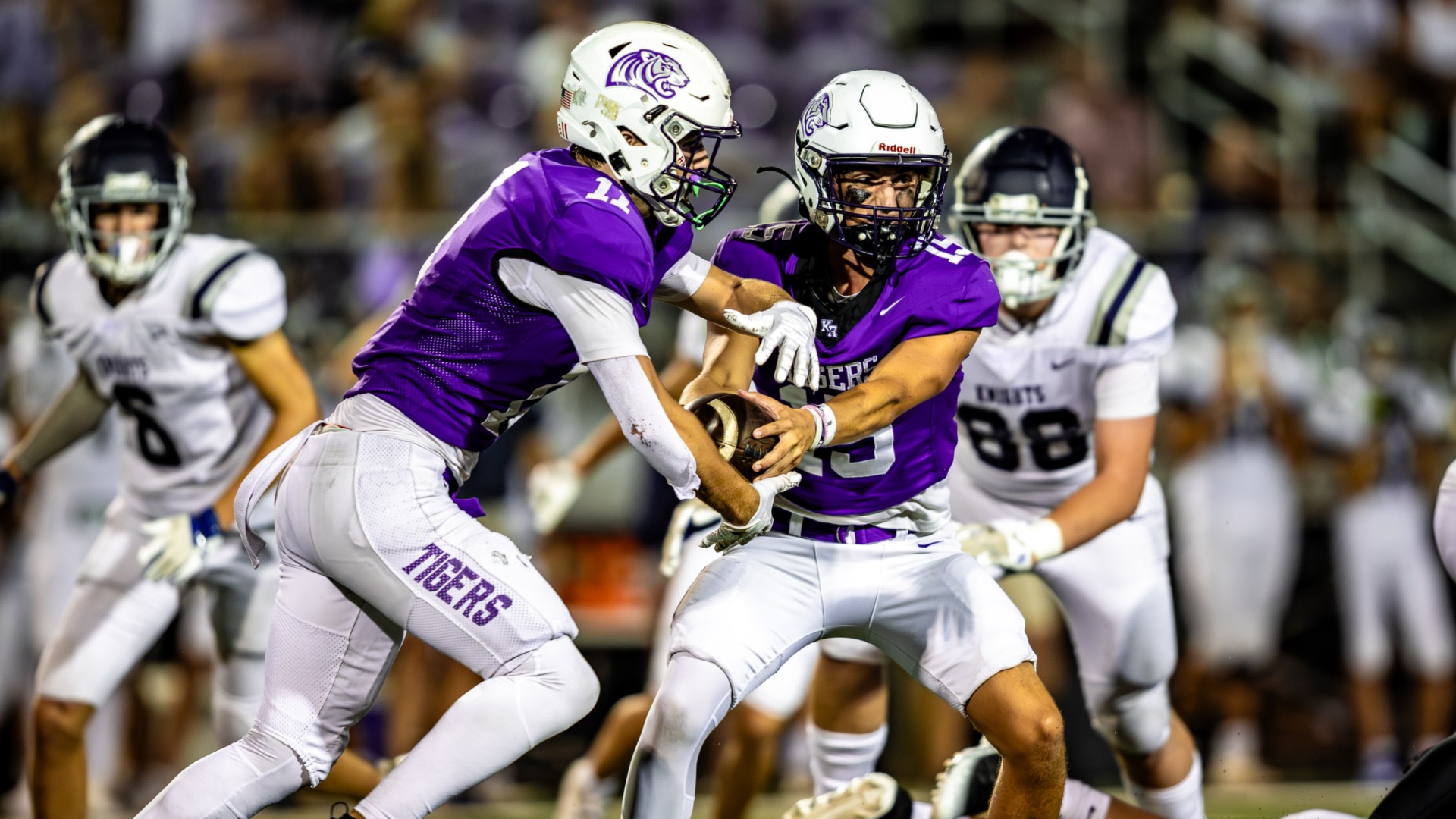 Football quarterback handing ball of to running back for King's Ridge Christian School