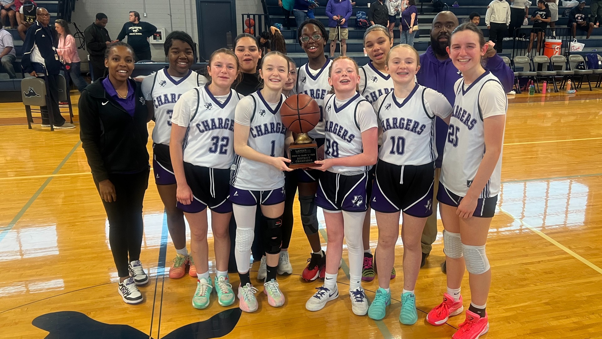 7th grade A girls basketball celebrating their championship