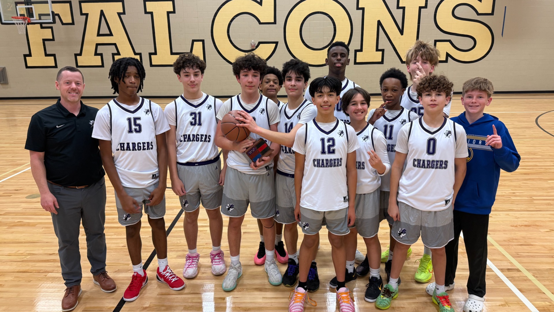 8th grade B Basketball team with the championship trophy