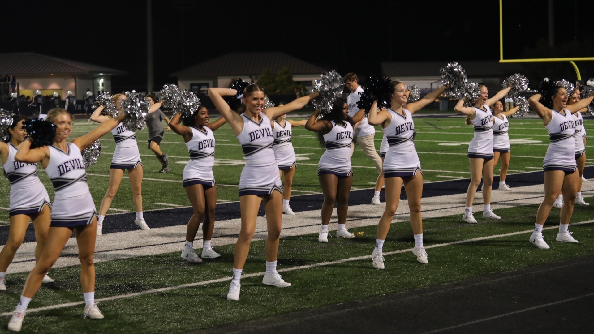 Varsity Football Cheerleader Pumping up the Crowd